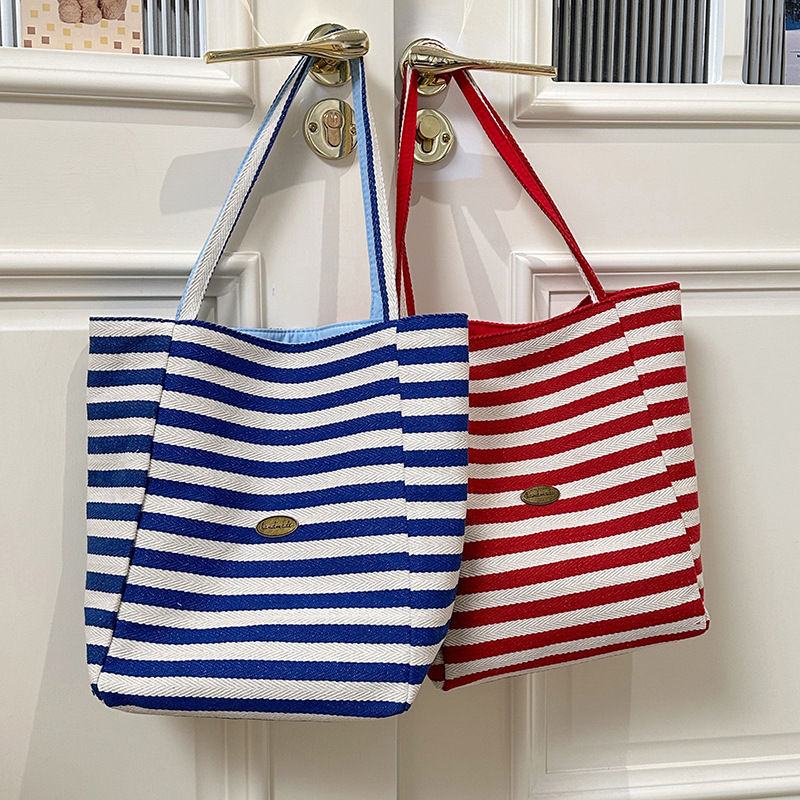 The new 2025 Korean version of the ins tote casual bag with striped canvas and a large-capacity single-shoulder tote bag are now on sale full figure