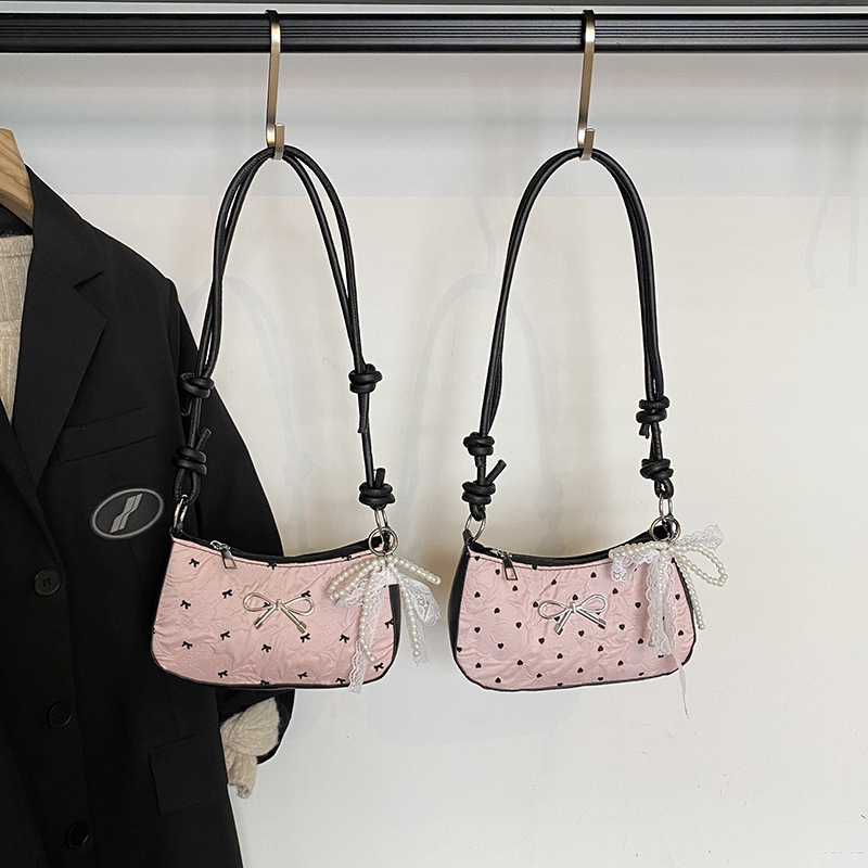 This high-end and light luxury single-shoulder bag is a new summer style. It features a cute pink bow-shaped small square bag and is versatile. It is a crescent-shaped underarm bag for women full figure