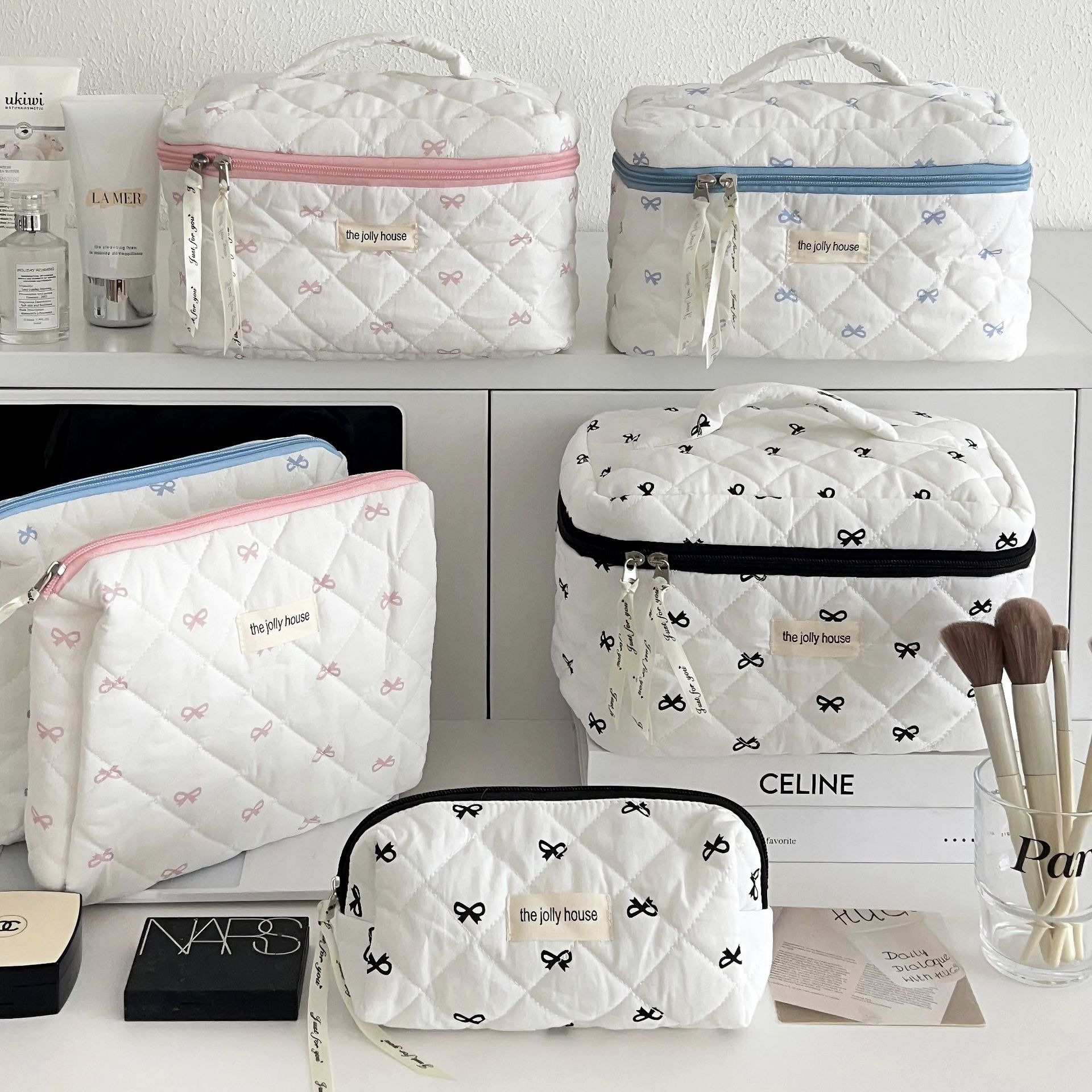 Original! A creamy blue bow makeup bag for women, a portable large-capacity storage bag for cosmetics and toiletries when traveling details Picture