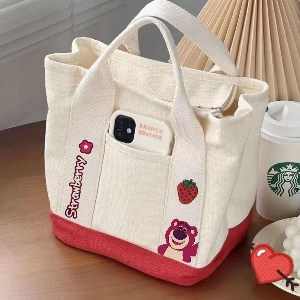 A small handbag is carried by a female student going out. She is carrying a 2024 new style bag, a mini canvas bag, and a Korean version bento bag for female students details Picture