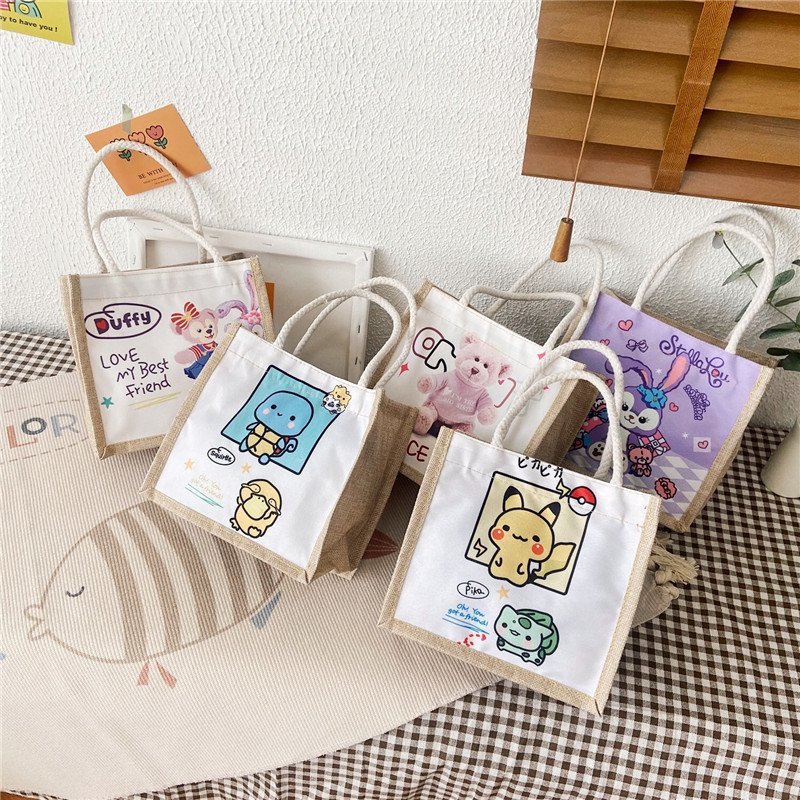 New canvas bag, a cute cartoon handbag for female students, a fresh and fashionable women's bag, and a casual hand-held small bag full figure