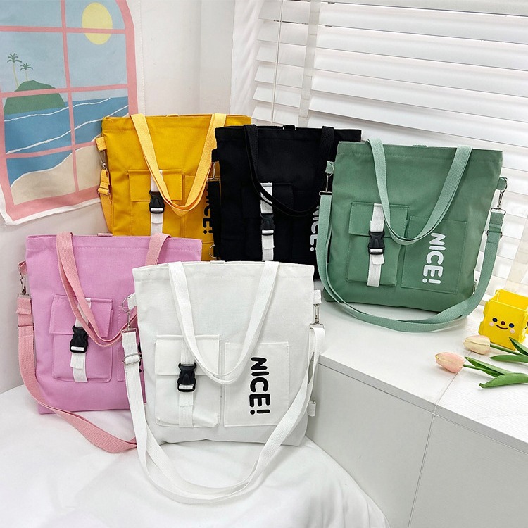 A large-capacity crossbody bag for spring 2024, featuring Japanese and Korean printed canvas for women and a student single-shoulder canvas bag with logo printing full figure