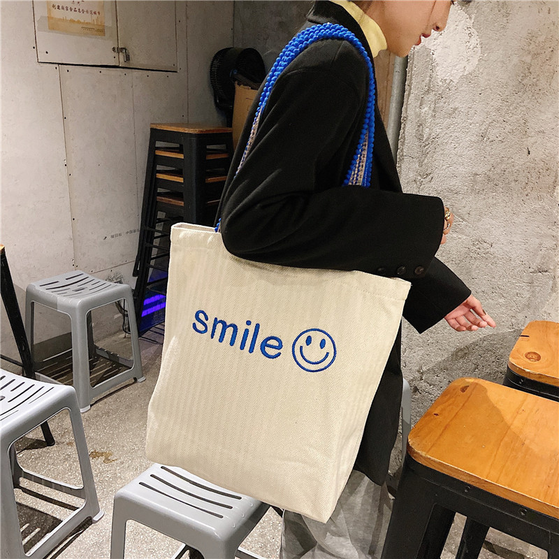 1119 Korean ins embroidered smiling face large-capacity single-shoulder bag with pom-pom shoulder strap for students' class girls canvas bag wholesale details Picture