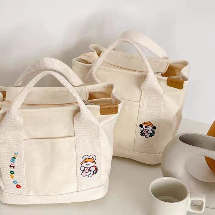 A cute Japanese-style canvas bag with dog letters, a new style for women, a handbag for moms going out, a bento bag, and a handbag for office workers details Picture