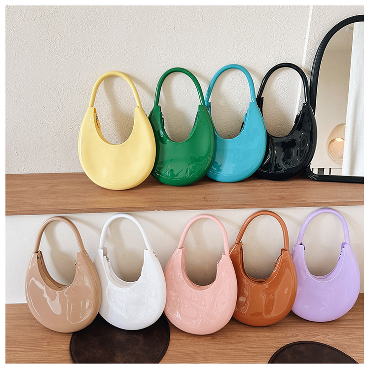 2025 New style fashionable crescent moon hand-held jelly bag, PVC trendy single-shoulder hand-held women's bag, simple patent leather bag full figure