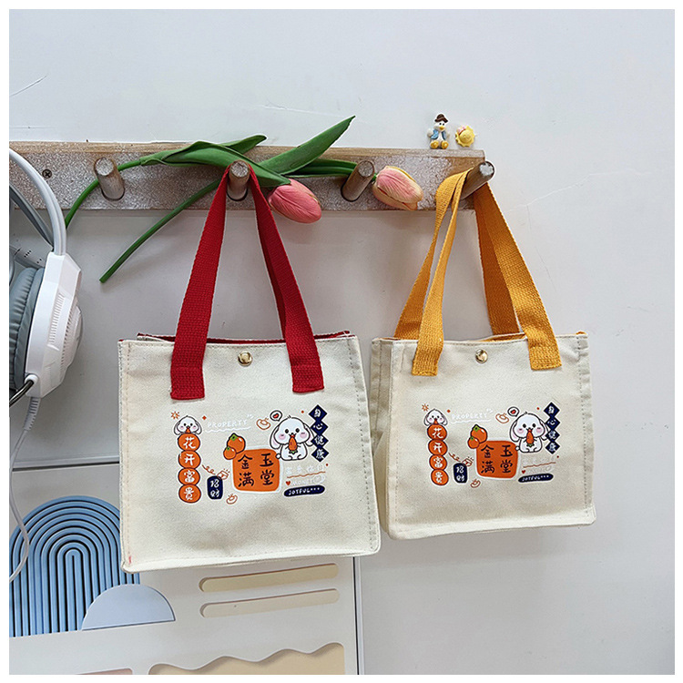 The new fashionable and casual canvas bag of Shishi Ruyi handbag, the cute bento bag for girls, and the hand-held bag are selling well details Picture