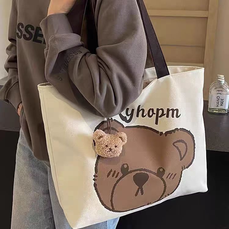 A new large-capacity casual bag for women, a cartoon bear canvas bag, and a single-shoulder tote bag for college students' commuting to class details Picture