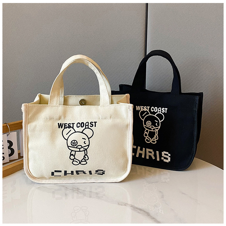 The new Japanese bucket-shaped tote canvas bag is simple and versatile. It's a trendy portable lunch bag with a large capacity full figure