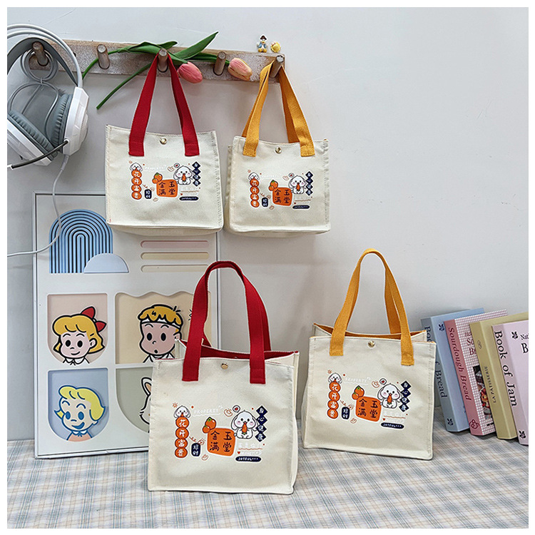 The new fashionable and casual canvas bag of Shishi Ruyi handbag, the cute bento bag for girls, and the hand-held bag are selling well full figure