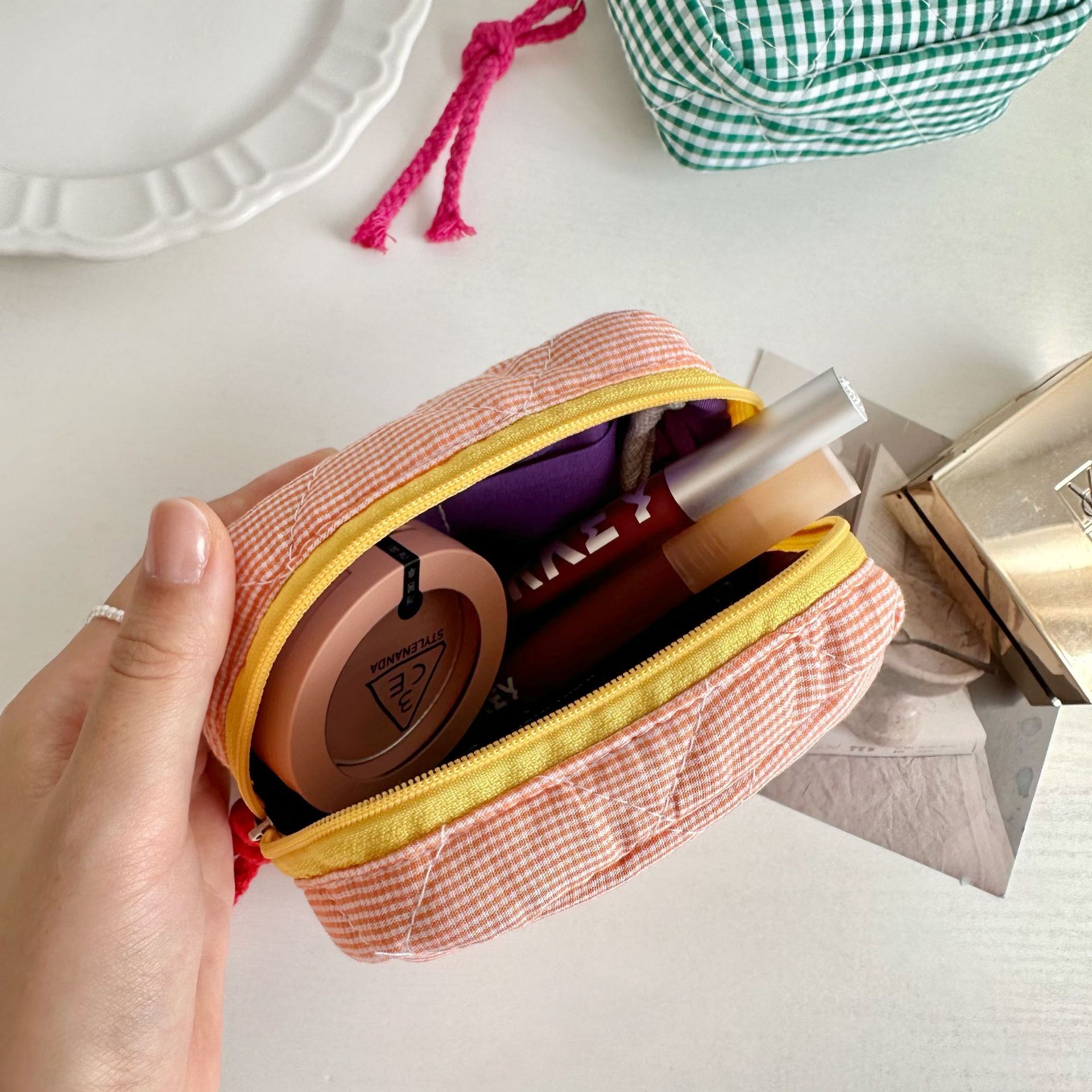 A Korean-style checkered square storage bag with a red envelope opening and compartments, a portable makeup bag, headphones, loose change and tofu bag Application Scenario