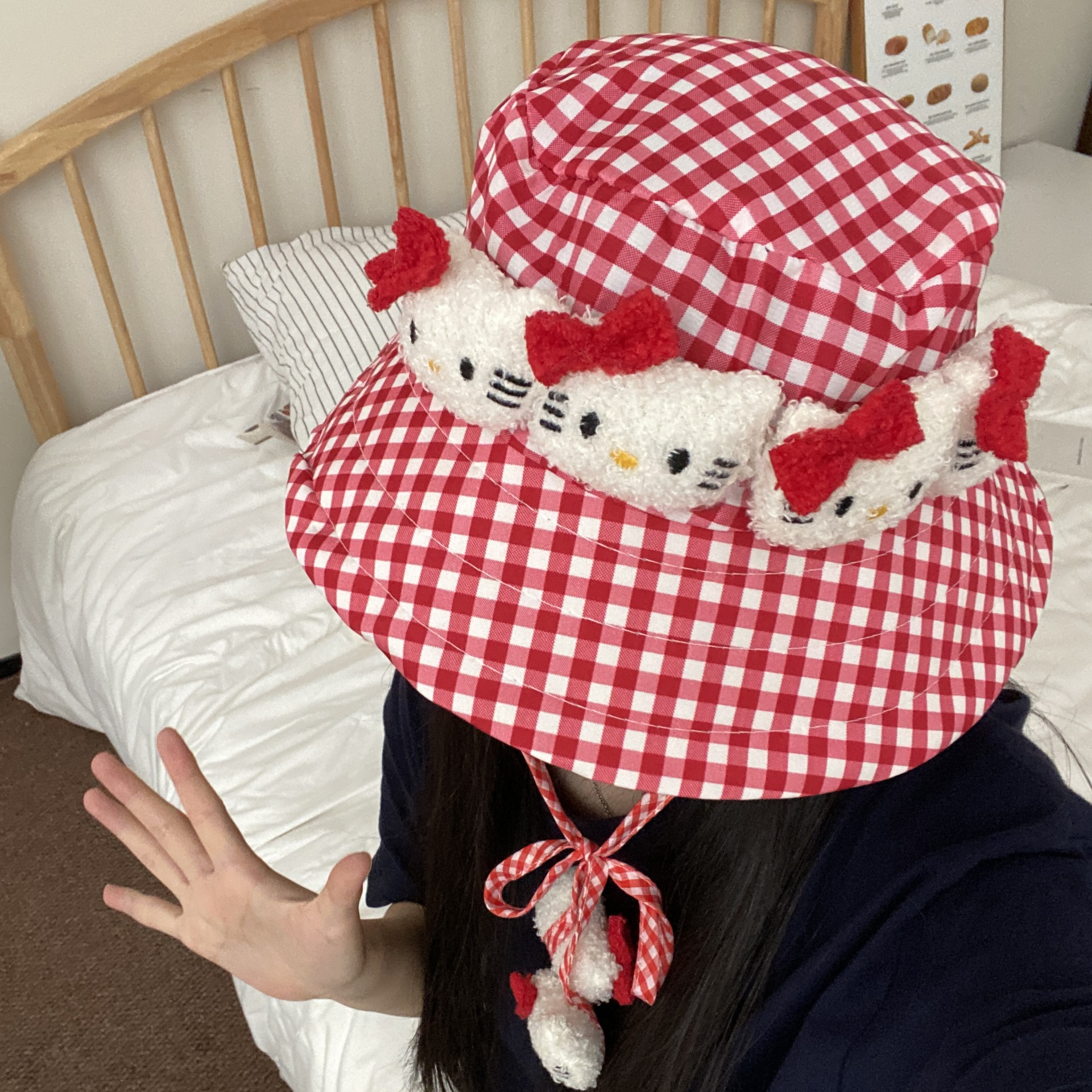 A cute Japanese red checkered fisherman's hat with a wide brim, a cat hat, a sweet beach picnic fisherman's hat, and a windproof hat Application Scenario