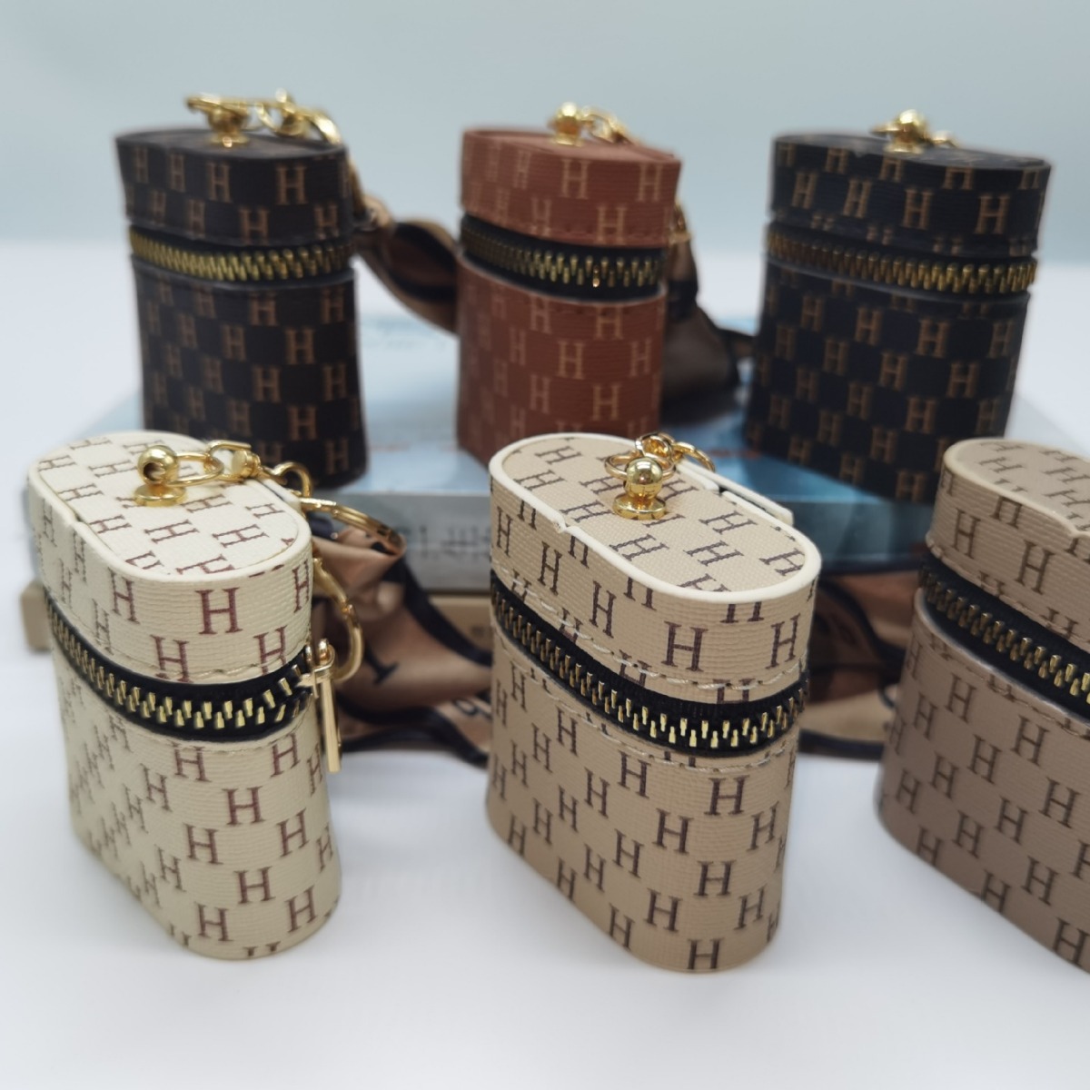 The new leather monogram coin purse keychain mini portable mouth red envelope storage wireless earphone case is cute full figure