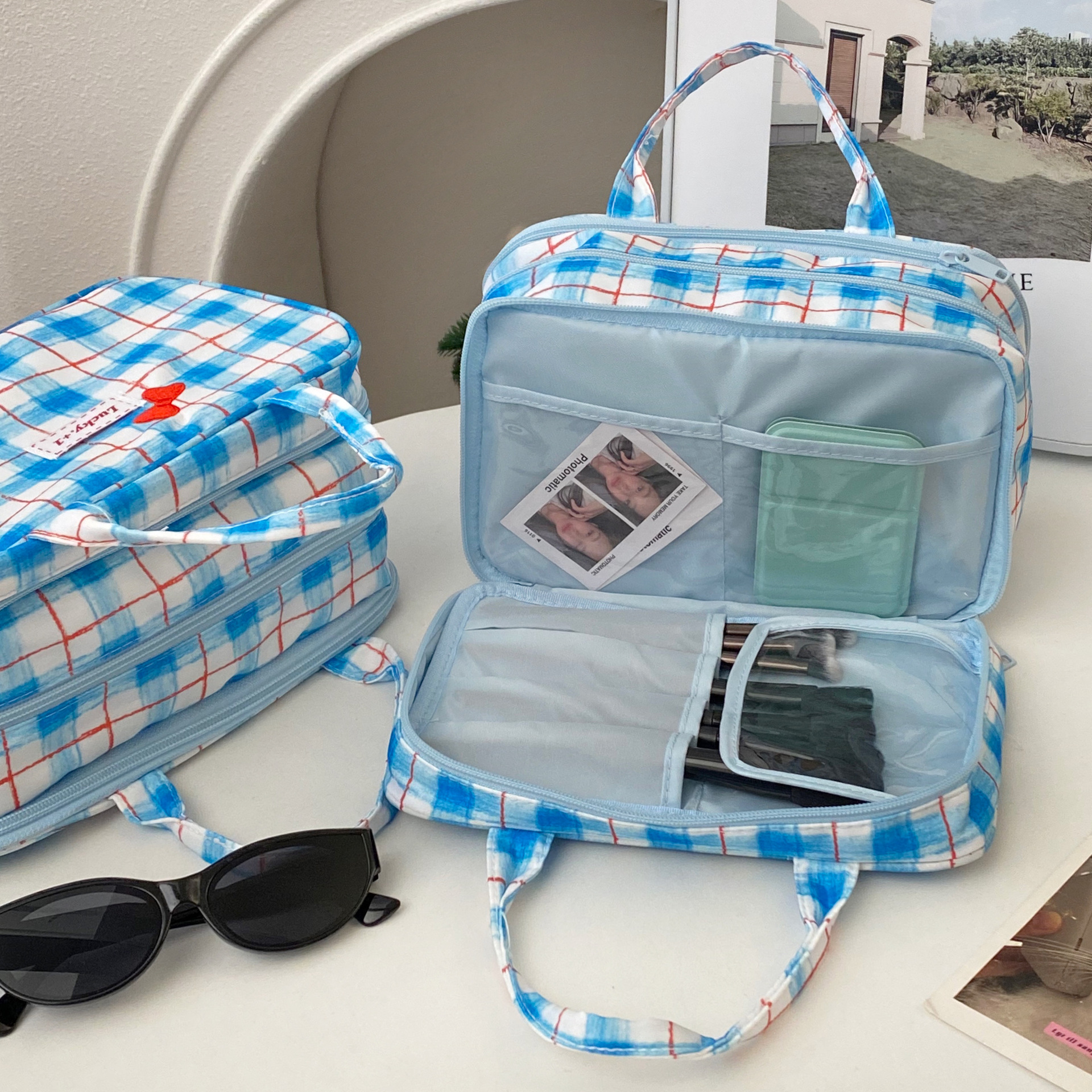 Cute bow three-layer makeup bag, large-capacity portable makeup storage bag, Korean-style checkered hand-held makeup bag for women Application Scenario