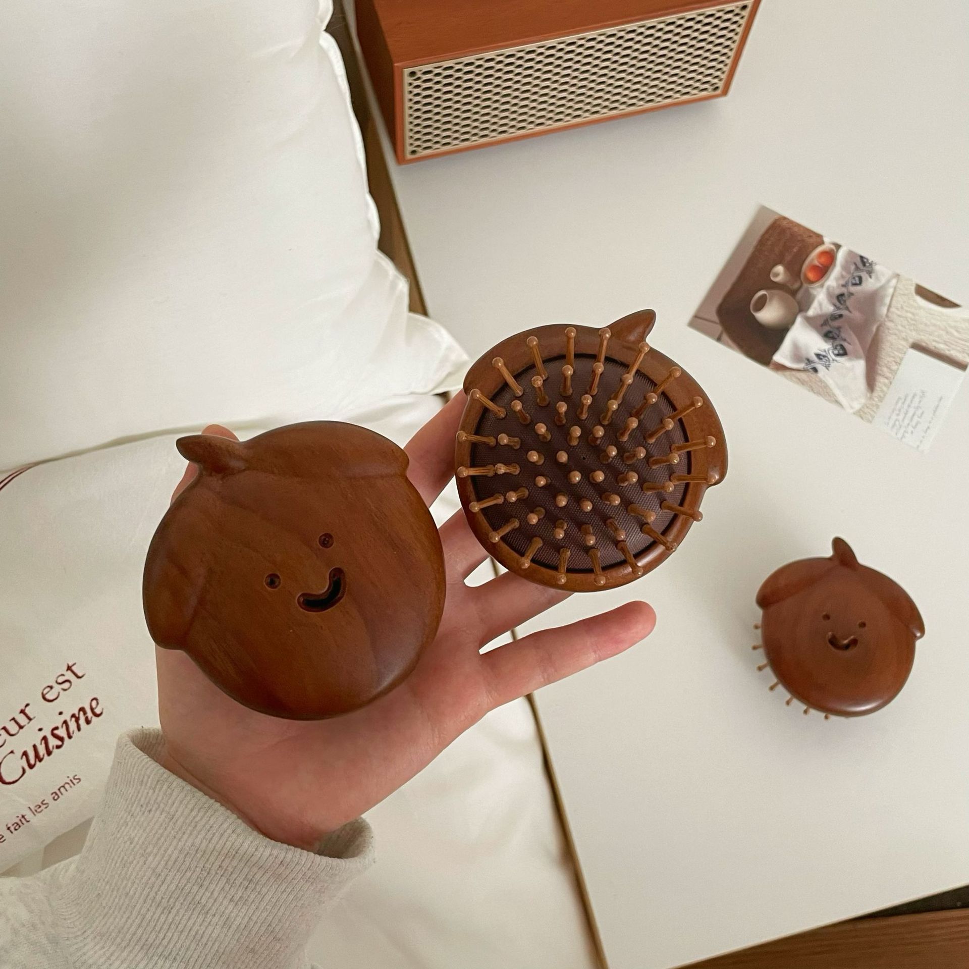 Cute smiling face sandalwood comb for women, portable airbag cushion for hair combing, skin meridian massage comb, mini round comb Application Scenario