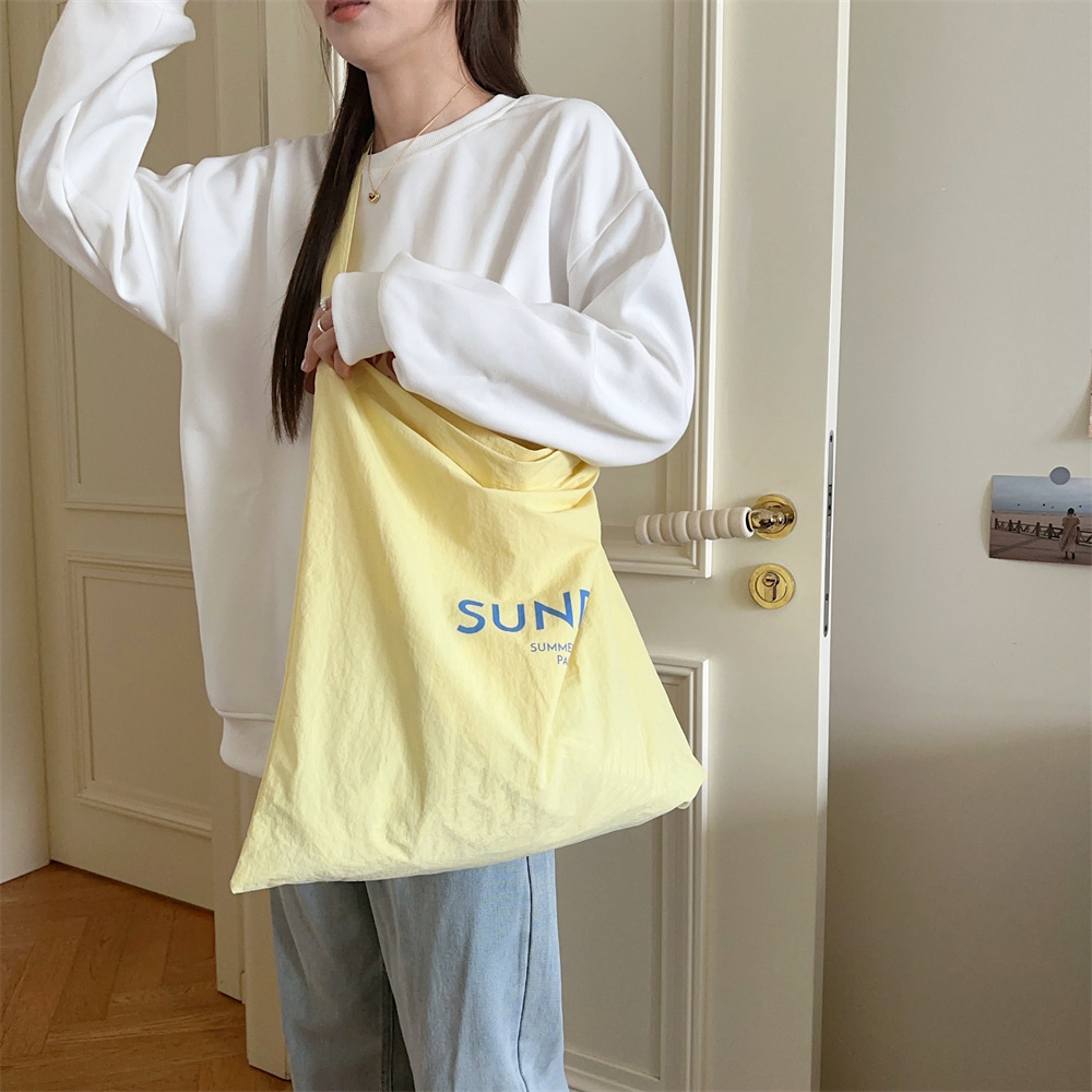 47271 New niche letter-printed single-shoulder bag, large-capacity commuting fabric bag, women's canvas bag, trendy shopping bag Application Scenario