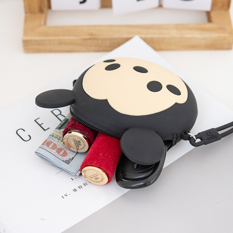A cute and petite Korean girl's mini zipper wrist cartoon silicone coin purse is slung diagonally across a small bag for storing coins Application Scenario
