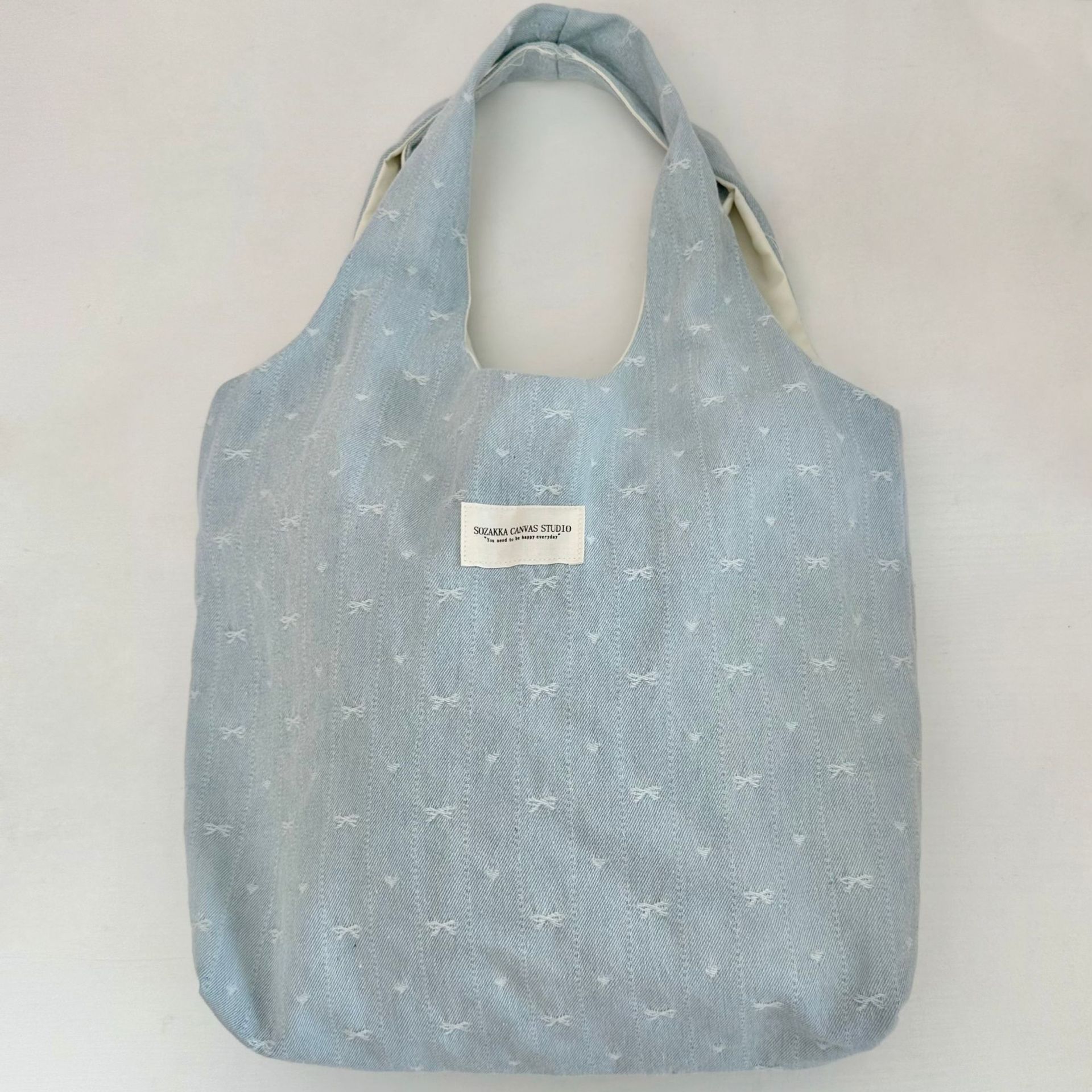 A fresh and simple denim bow vest bag for women, light blue bow embroidery, unique and versatile, large-capacity single-shoulder bag Item Picture
