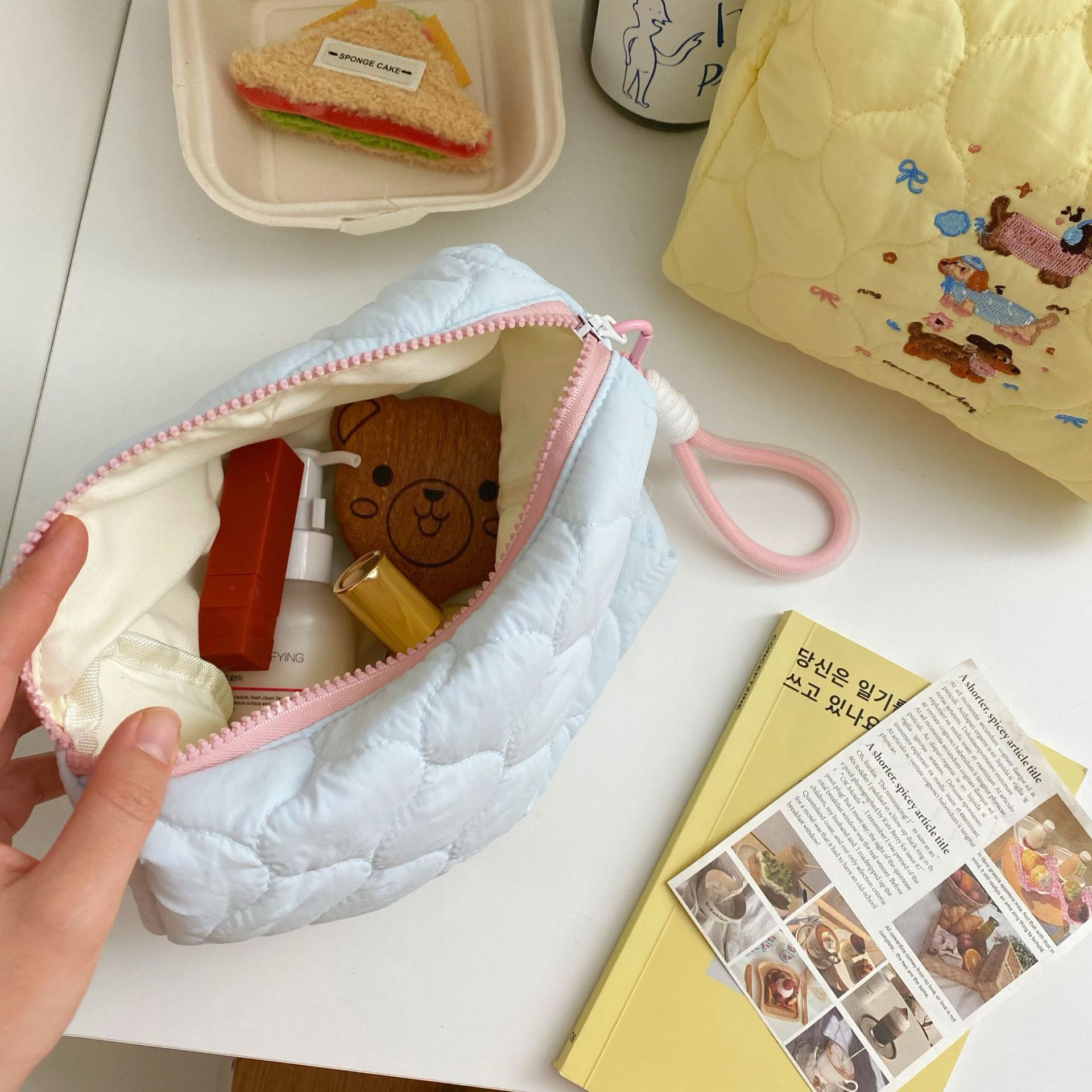Cute embroidered puppy makeup bag, portable hand-held bag with lanyard, large capacity travel skin care products, hand-held bag mouth red envelope Application Scenario
