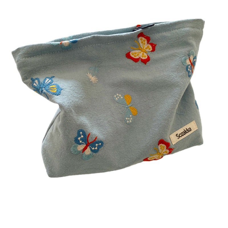 110221 Sky blue butterfly-embroidered cosmetic bag, portable zipper storage bag, easy to carry, hand in hand, a coin purse for women Application Scenario