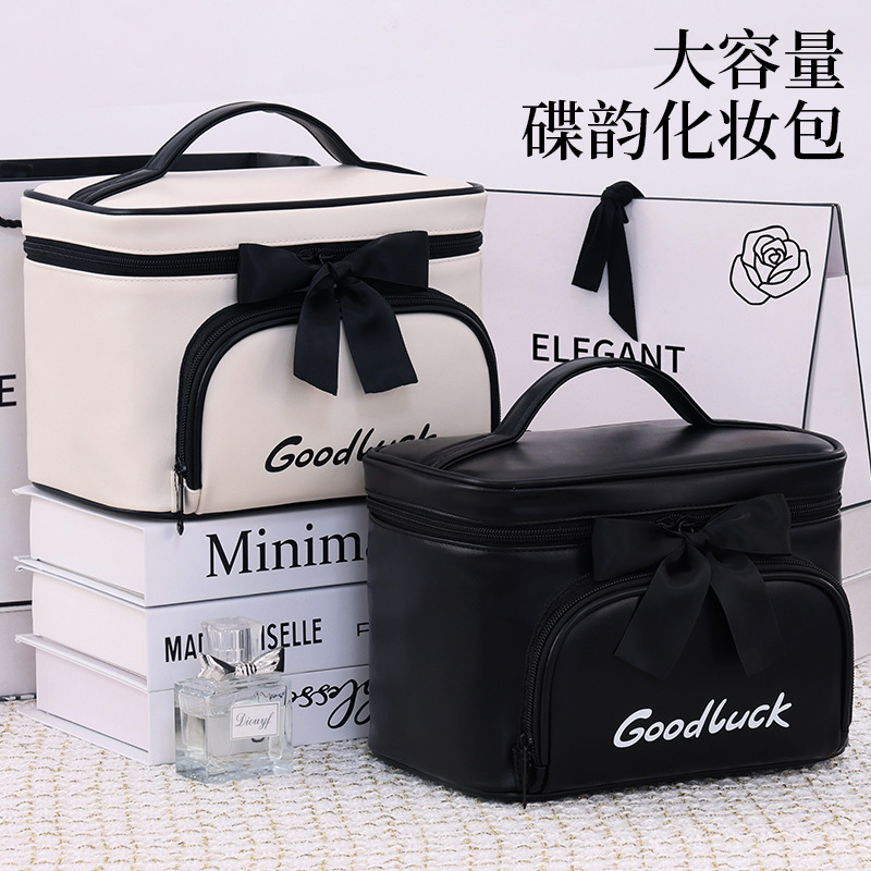 Simple and elegant bow makeup bag, large-capacity waterproof hand-held toiletry bag, travel and portable makeup bag for going out full figure