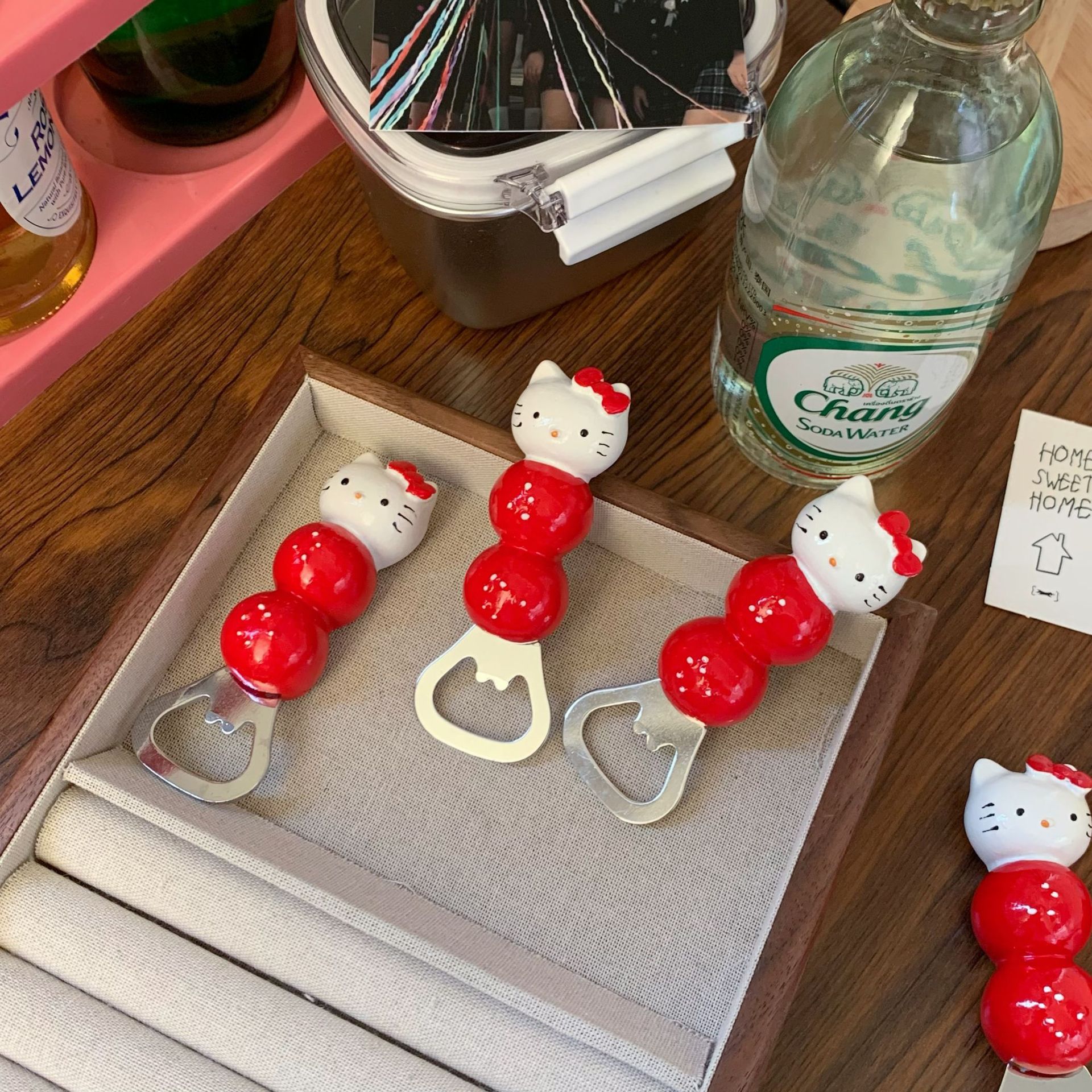 Cute cat sugar-coated haws bottle opener, high appearance level, irregular pose decoration props, household dining table beer screwdriver Application Scenario
