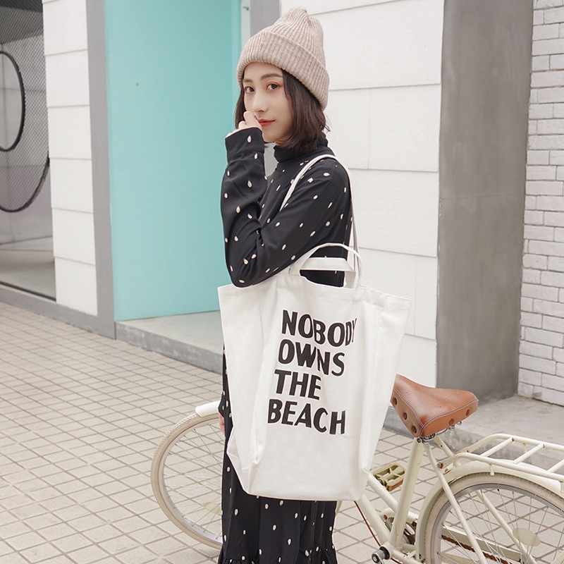 E132 Korean version artistic and simple letter single-shoulder canvas bag for female students, large-capacity hand-held shopping bag for sourcing Specification drawing