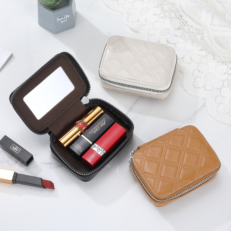 A small mini makeup bag made of pu leather with a red envelope, a fashionable three-in-one lipstick with a mirror details Picture