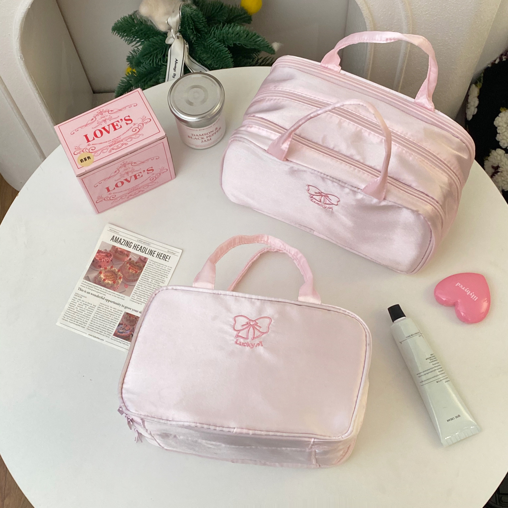 A pink three-layer makeup bag for young girls, a large-capacity portable hand-held makeup bag, and a cosmetic storage bag for travel and business trips full figure