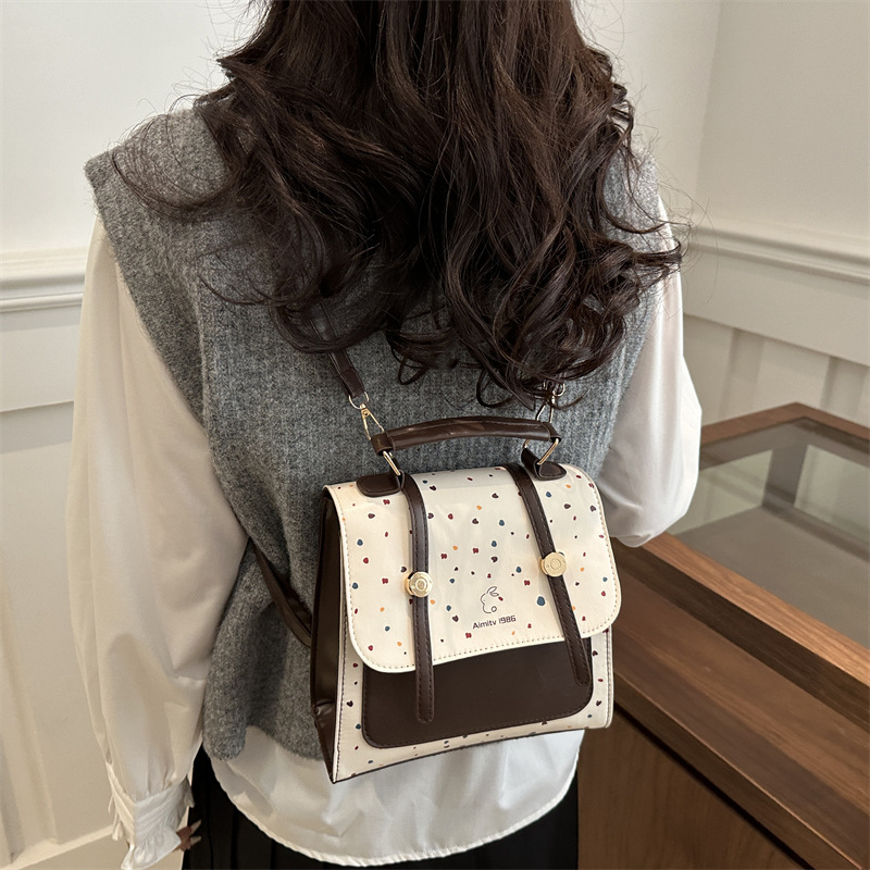 A new 2025 fashionable, retro, simple and stylish polka dot texture, large-capacity, college-style simple backpack for women's commuting Application Scenario