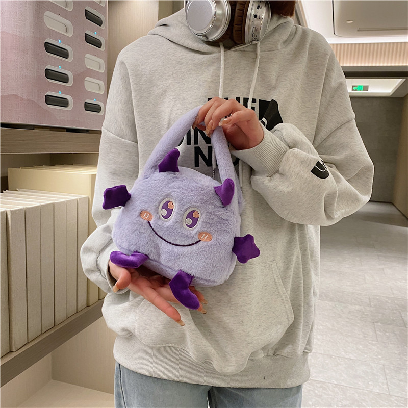 Autumn and winter fashion plush cartoon hand-held little monster three-eyed boy flip bag, large-capacity double-sided women's bag storage bag details Picture