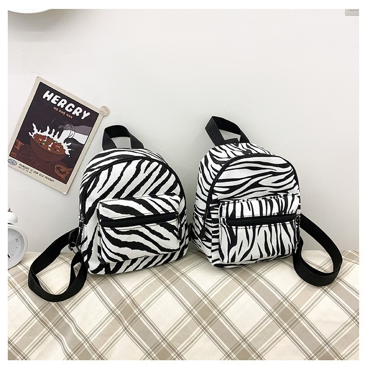 This mini canvas backpack is super popular on Instagram. It's a cute commuting makeup bag with cow texture. It's a versatile student bag full figure