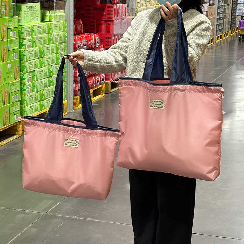 Foldable drawstring shopping bag, large waterproof Oxford cloth handbag, portable large-capacity supermarket eco-friendly grocery bag Application Scenario