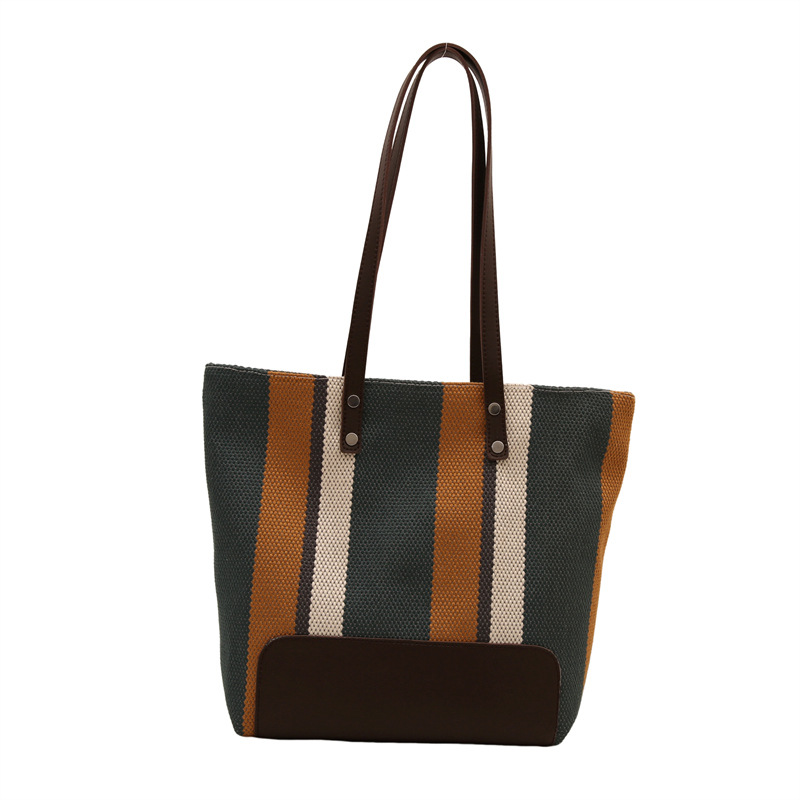 The new large-capacity commuting striped canvas bag and travel handbag of the casual single-shoulder tote bag for women in 2025 are selling well Item Picture
