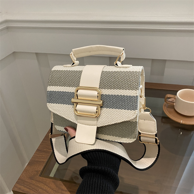 A niche design women's bag for 2024, featuring a color-blocking and patchwork small square bag with a feminine feel. It is a single-shoulder, hand-carry and underarm bag full figure