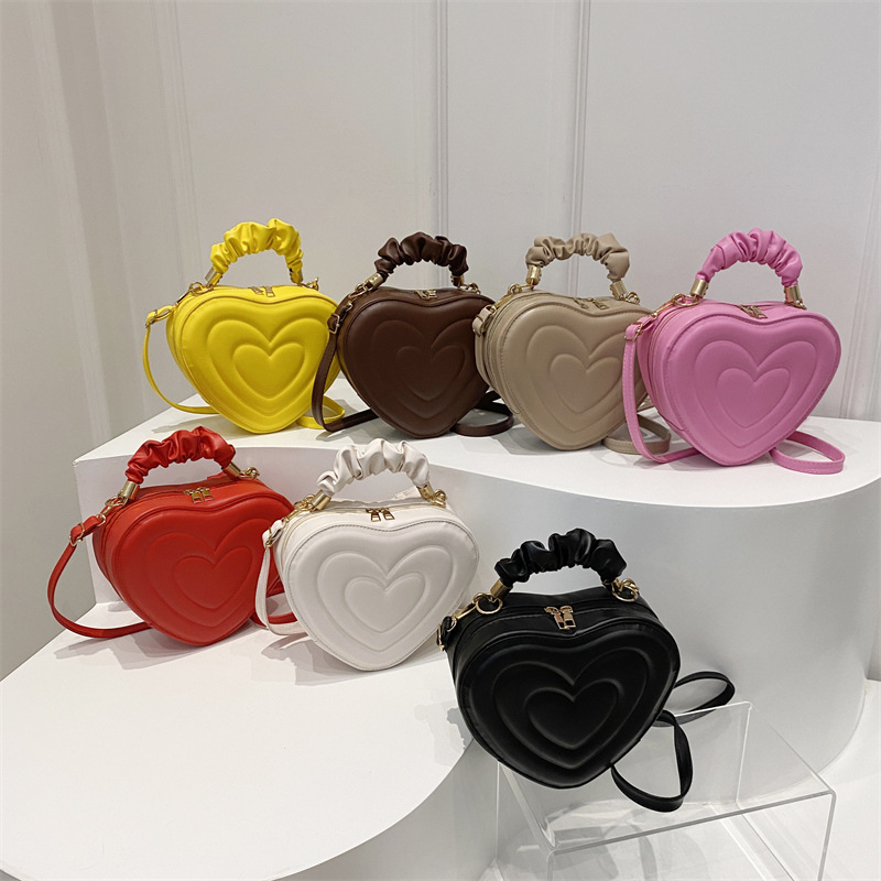 Retro solid color embossed small bag for women, 2024 new style, fashionable and trendy casual single-shoulder bag, texture, slanted cross heart bag full figure