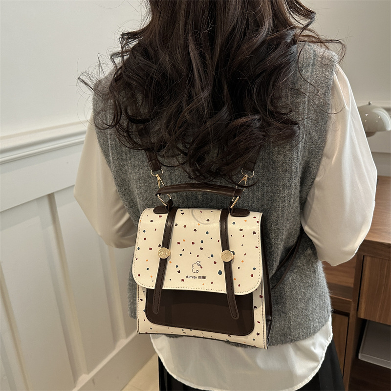 A new 2025 fashionable, retro, simple and stylish polka dot texture, large-capacity, college-style simple backpack for women's commuting Specification drawing