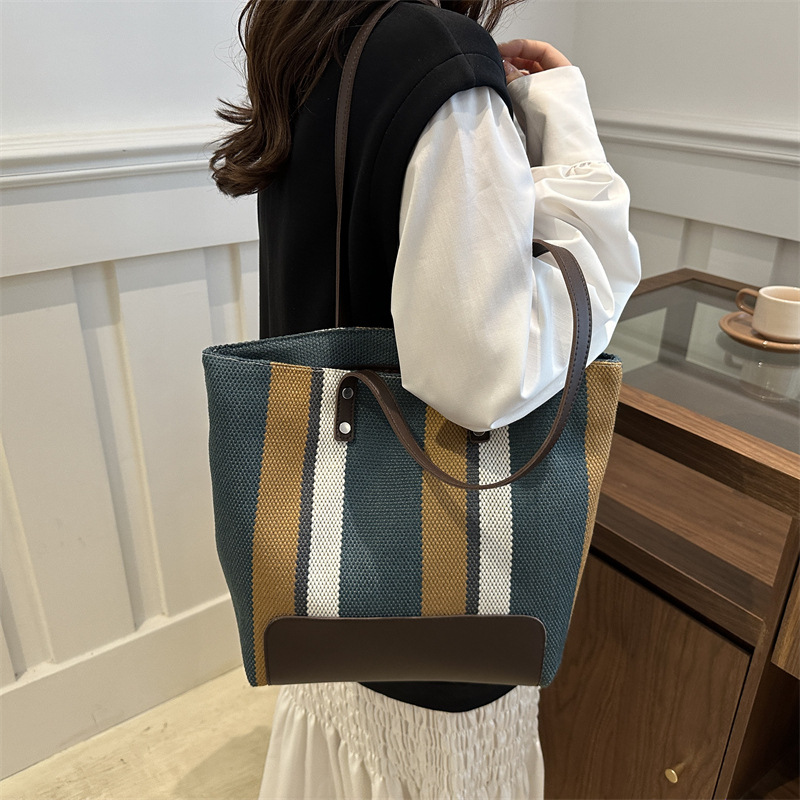 The new large-capacity commuting striped canvas bag and travel handbag of the casual single-shoulder tote bag for women in 2025 are selling well details Picture