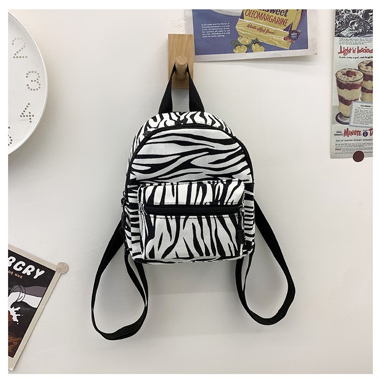 This mini canvas backpack is super popular on Instagram. It's a cute commuting makeup bag with cow texture. It's a versatile student bag details Picture