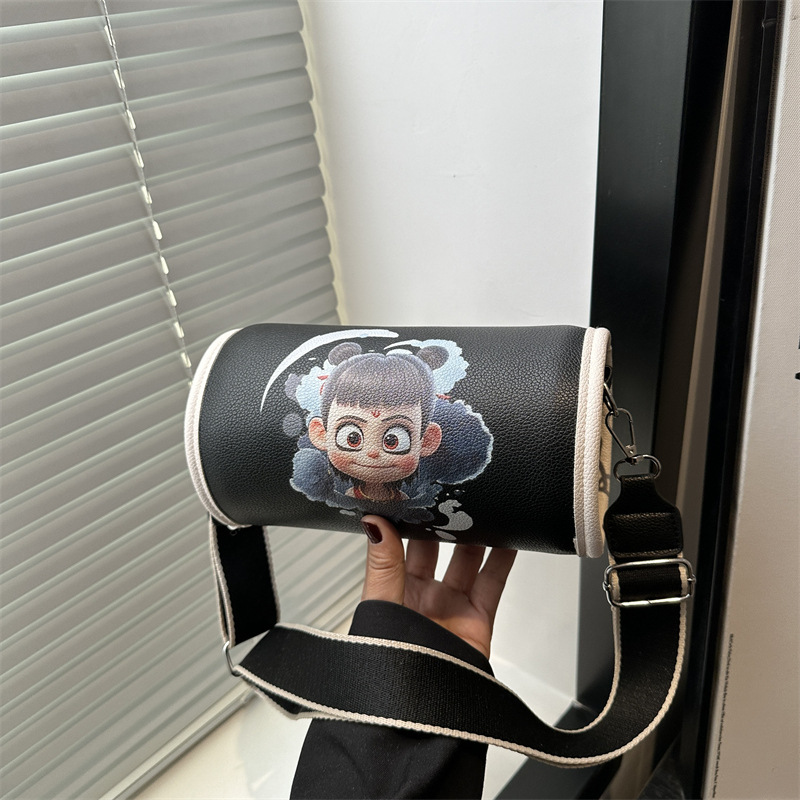 The new Spring 2025 cartoon-printed cylindrical bag with large capacity and wide shoulder strap, single-shoulder crossbody bag, is crossing the cross-border trend full figure