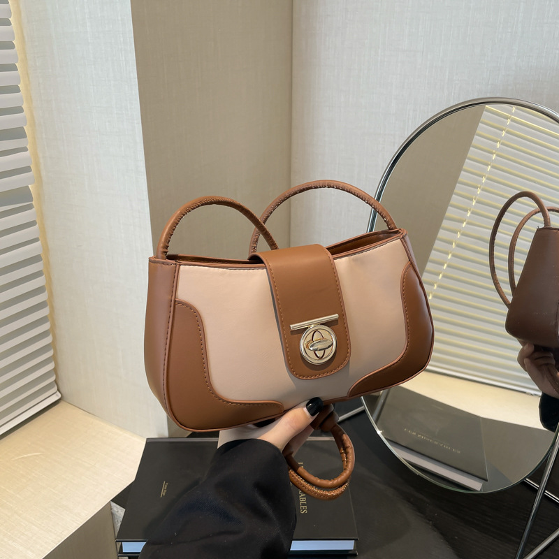 A trendy single-shoulder underarm bag with contrasting colors and a unique style for women's 2024 winter, featuring a stylish and individualistic crossbody crescent moon bag full figure