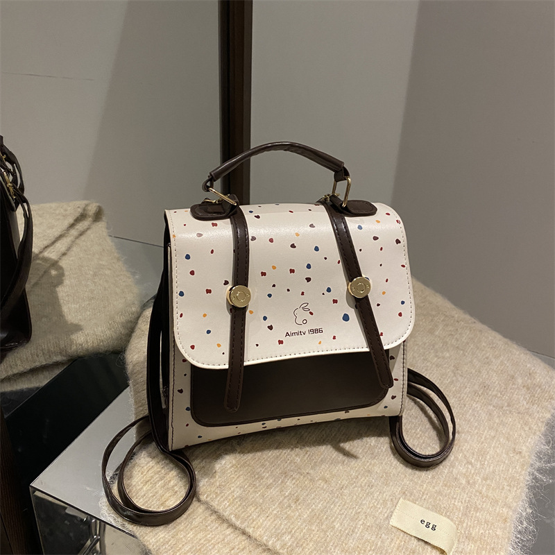 A new 2025 fashionable, retro, simple and stylish polka dot texture, large-capacity, college-style simple backpack for women's commuting full figure