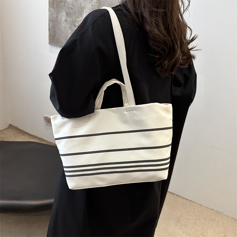 A new Korean canvas bag, striped hand-held shoulder tote bag, large-capacity women's bag, versatile commuting crossbody bag details Picture