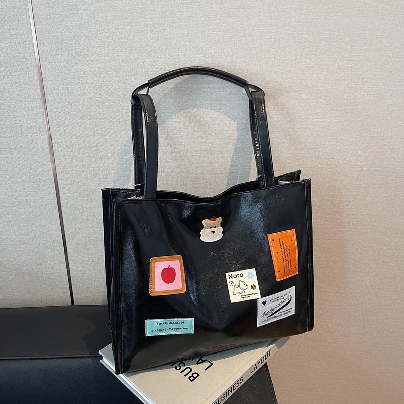 The 2025 new backpack is fashionable and versatile. The large-capacity tote bag is simple and cute for women. The cartoon sticker single-shoulder bag is trendy details Picture