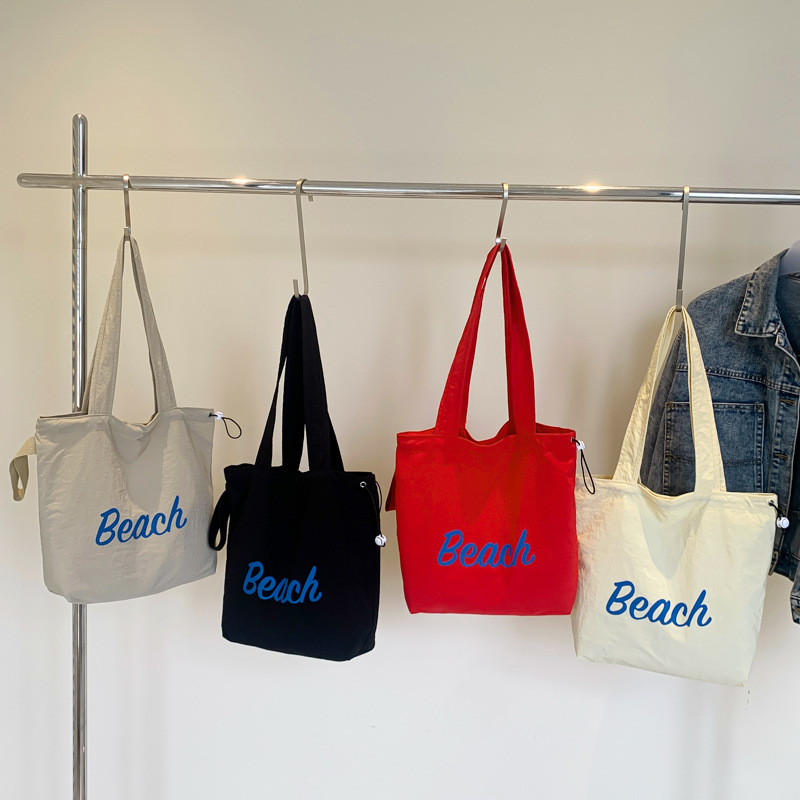 Korean summer new canvas bag, large-capacity shopping bag, commuter single-shoulder bag, simple letter drawstring handbag Application Scenario