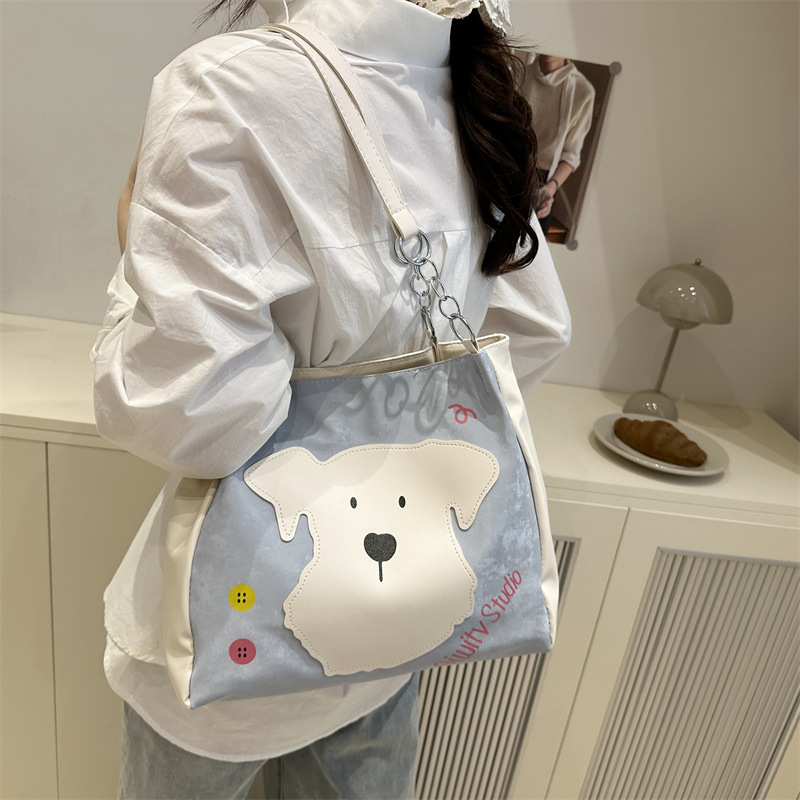 This is a new style of women's bag for 2025, featuring a fashionable and cute dog-patterned design. It's a single-shoulder crossbody bag and a literary bucket bag details Picture