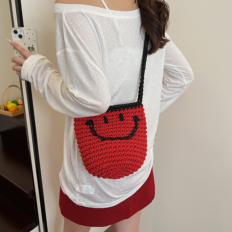 2025 New style simple bucket bag, niche women's bag, smiling knitted bag, single-shoulder bag for going out, and crossbody bag for seaside travel Application Scenario