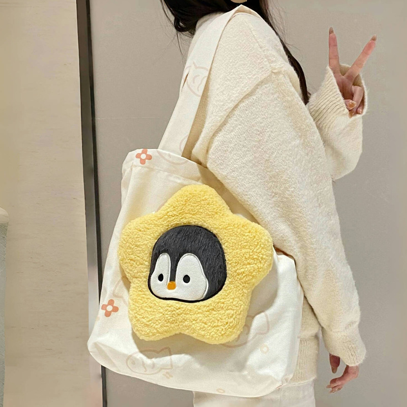 The new printed canvas bag combination is cute and versatile. It features a small penguin plush crossbody bag and a large-capacity tote bag for classes full figure