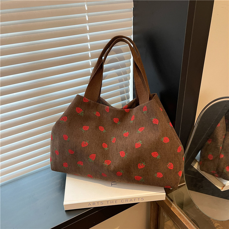 A large-capacity, simple and fashionable school-style personalized single-shoulder bag for commuting, a new spring 2025 hand-held tote bag full figure