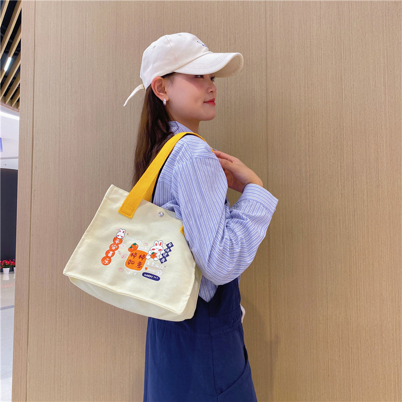 2024 New single-shoulder crossbody cute little rabbit hand-held bento bag, student canvas hand-held supplementary class fresh and sweet bag Application Scenario