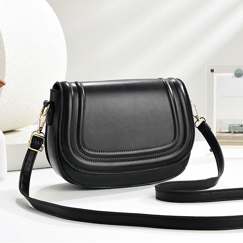 The 2025 new saddle bag women's bag features a niche design. It is a solid-color flip-top embossed fashionable women's crossbody bag full figure